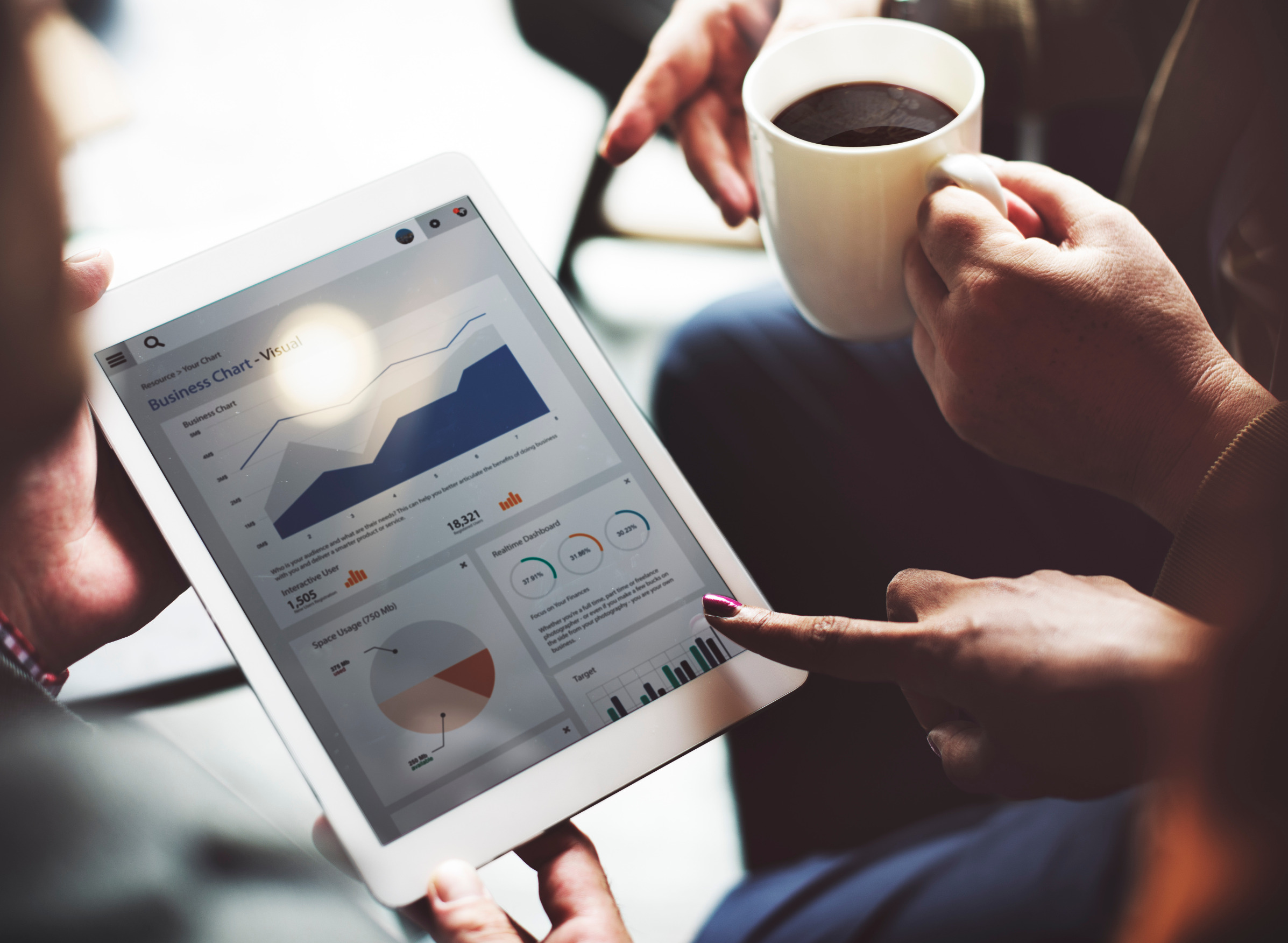 Business people looking at data and drinking coffee