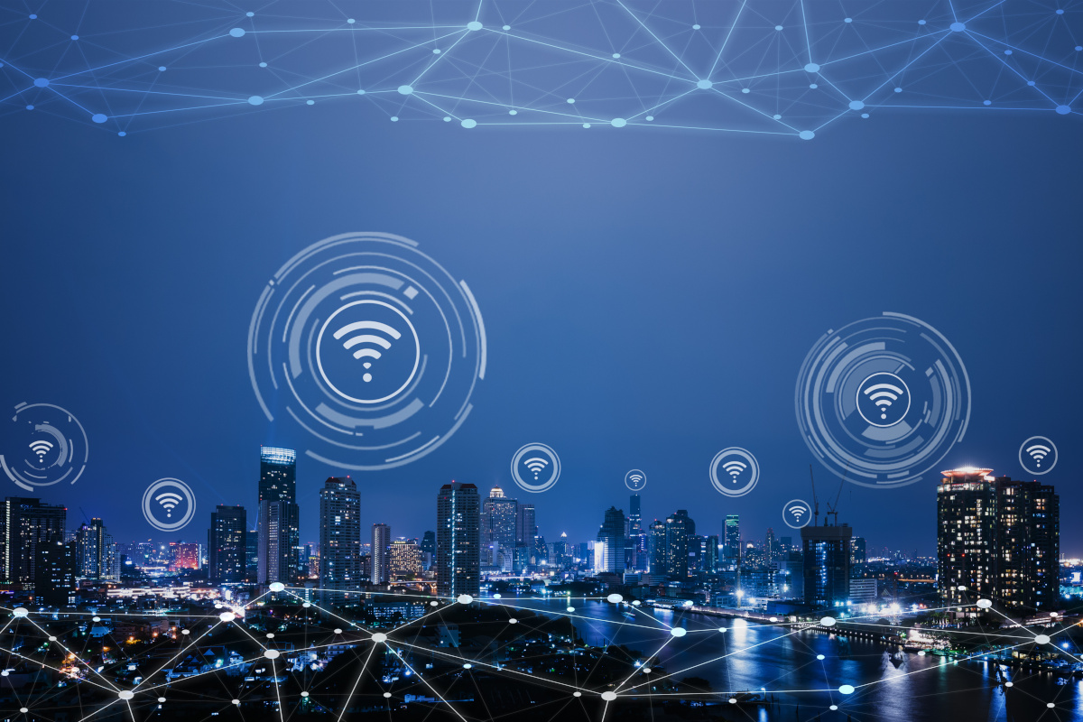 City at night with network connections icons floating above it