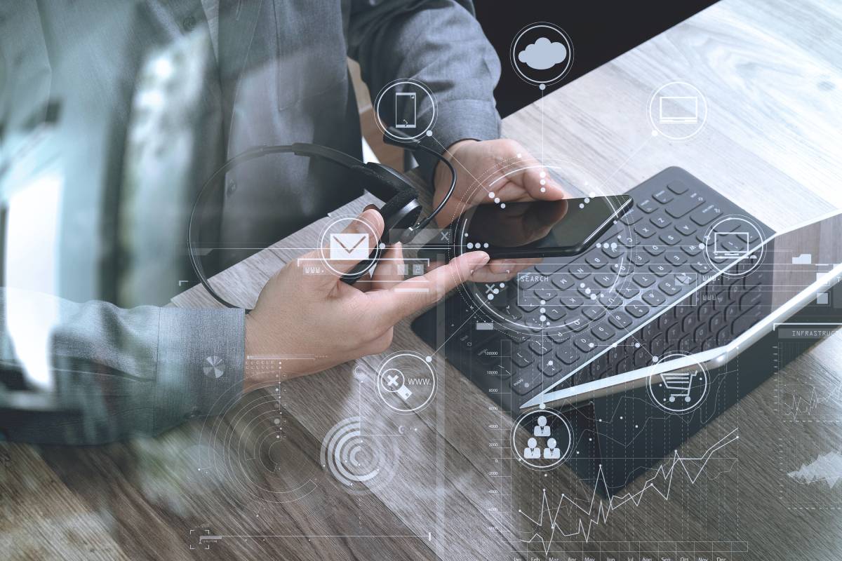 Man using mobile phone and working on laptop